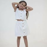 Mamarill Girls Classy Co-Ord Set In Crisp White, Elevated By Stylish Wooden Buttons On The Sleeveless Top.