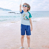 2 Pcs T-Shirt & Shorts Blue “Groovy” Cartoon Print UPF 50+ Kids Swimwear with Matching Swim Cap With Free Wash Bag
