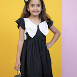 Mamarill Girls Chic Bow Tunic Is A Chic Black Dress With A Distinctive White Bow Accent On The Chest.